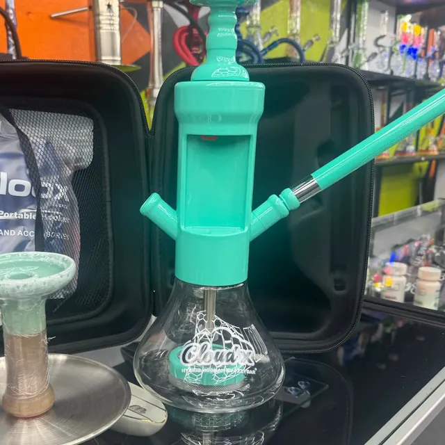 A Cloud X portable hookah in front of the hookah wall