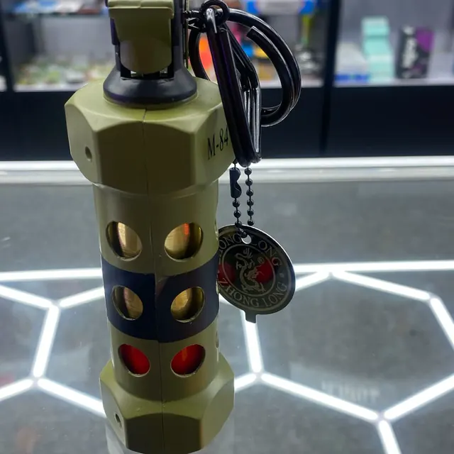 A grenade-shaped torch lighter over the hex-lit glass counter