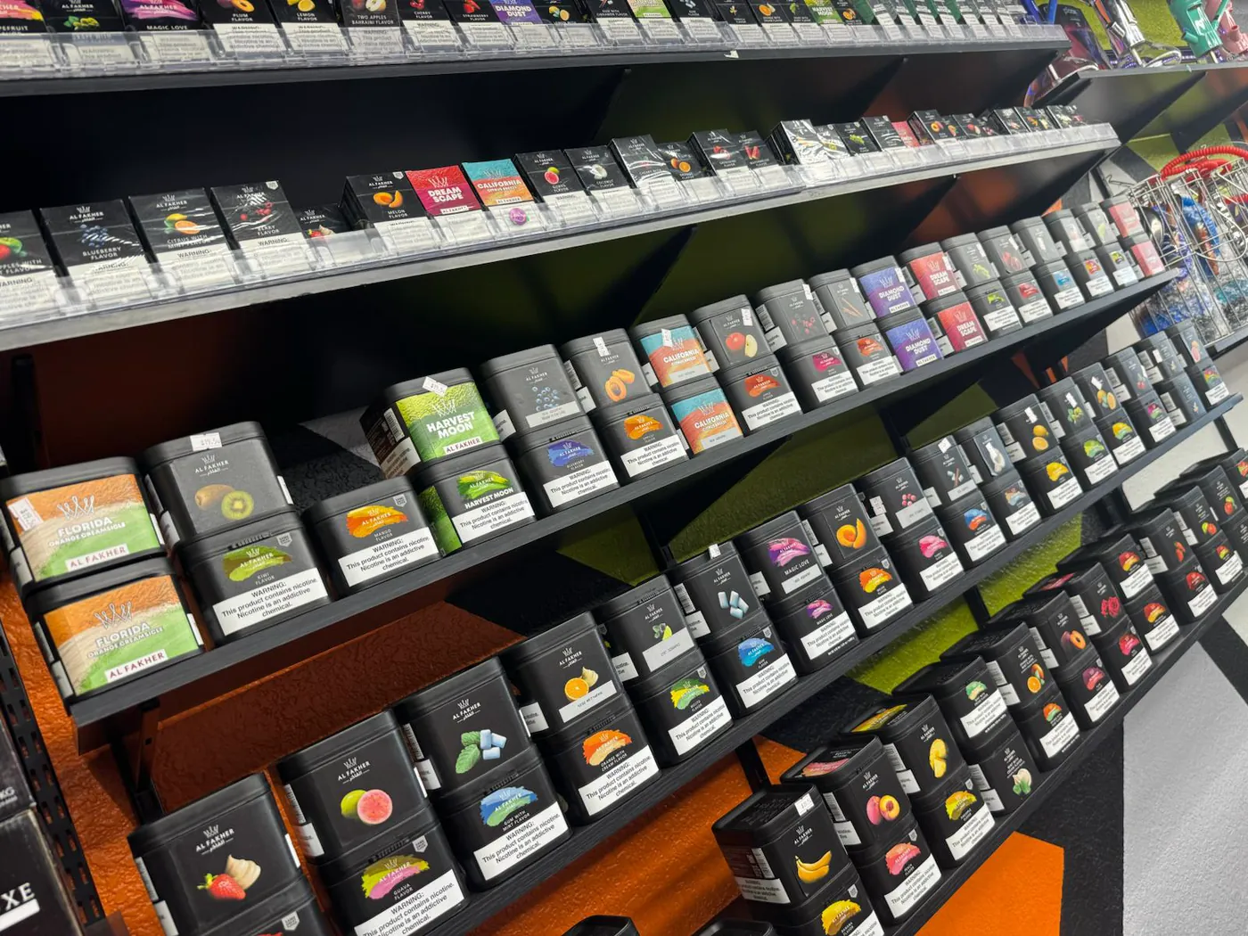 Shelves of Al Fakher shisha tins in every flavour